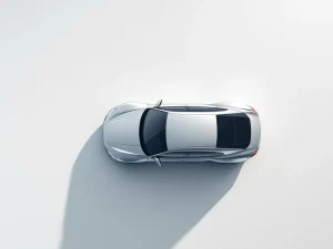 Zilveren auto van bovenaf met documenticoon en sleutel op witte achtergrond, professionele mobiliteitsoplossing